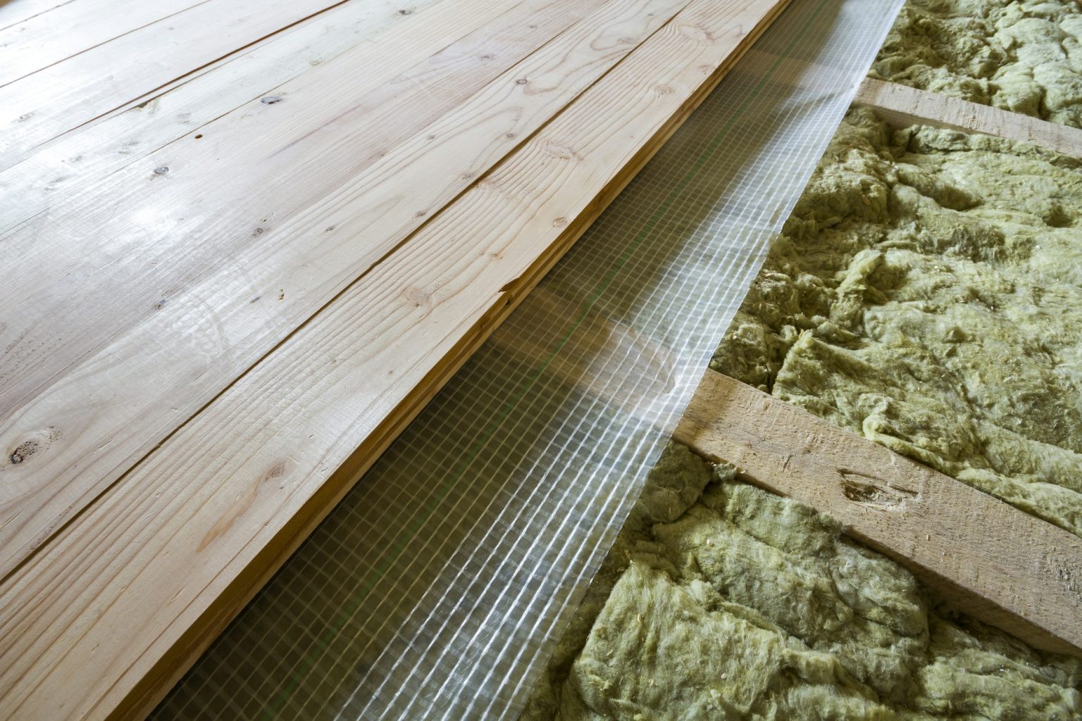 Installation of new floor of wooden natural planks and mineral wool insulation for isolation